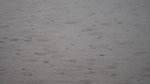 4K Drops of rain falling on the surface of a river Stock Footage 100360533