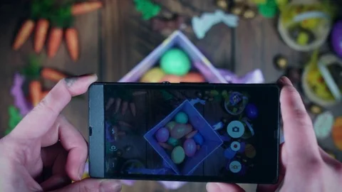 4K Easter Composition From Above Of Smartphone Taking Picture Stock Footage 72965004