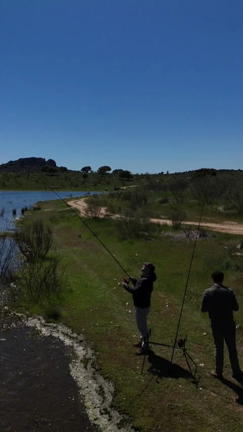 4K Editorial aerial low orbit shot rotating around a fisherman at reservoir Stock Footage 336205375