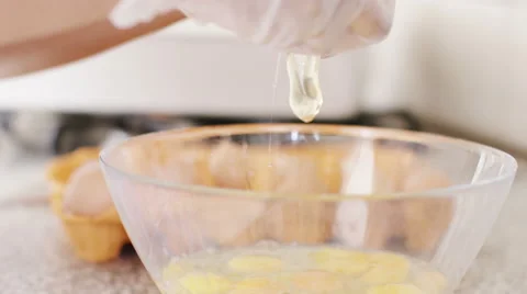 4K Egg being opened to put yolk in a mixing bowl, in slow motion Stock Footage 56194800