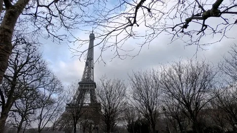 4K, Eiffel Tower in back of tree branches at winter day Paris, France. -Dan Stock Footage 106910551