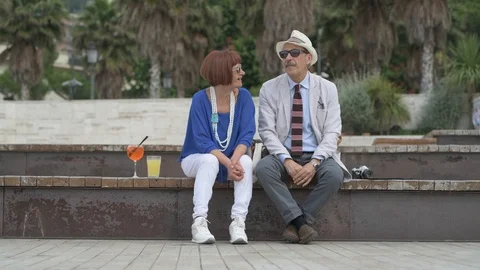 4K elderly couple having a cocktail on the beach Stock Footage 90802583