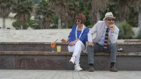 4K elderly couple having a cocktail on the beach Stock Footage 90804465