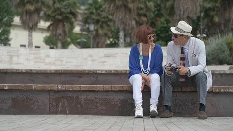 4K elderly couple taking pictures on the beach Stock Footage 90802702