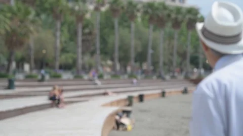 4K elderly couple walking on the beach with palm trees in the background Stock Footage 90803261