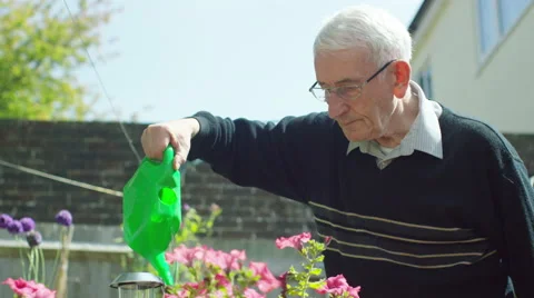 4K Elderly man alone, doing some gardening at home.  Stock Footage 63281586