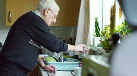 4K Elderly man doing washing up at home. Shot on RED Epic Stock Footage