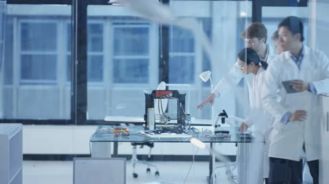 4K Electronic engineering team working in the lab with 3D printer Stock Footage 67852455