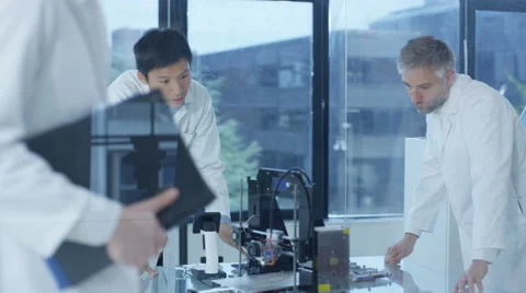 4K Electronic engineering team working in the lab, testing 3D printer Stock Footage 67864132