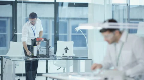 4K Electronic engineering team working in the lab, testing 3D printer Stock Footage 67883413