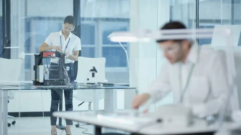 4K Electronic engineering team working in the lab, testing 3D printer &amp; circuit  Stock Footage 67887724