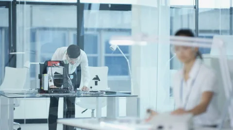 4K Electronic engineering team working in the lab, testing 3D printer &amp; circuit  Stock Footage 67890826