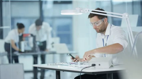 4K Electronics engineer working in lab building &amp; testing electronic devices Stock Footage 67878475