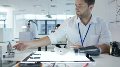 4K Electronics engineering team building &amp; testing robotics &amp; electronics Stock Footage 68027876