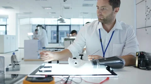 4K Electronics engineering team building &amp; testing robotics &amp; electronics Stock Footage 68029223