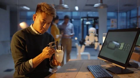 4K Electronics engineering team using 3D printed components to create a robot Stock Footage 73833994