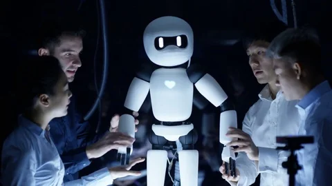 4K Electronics engineers collaborating on design of robot in dark lab Stock Footage 71209189