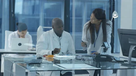 4K Electronics engineers in discussion in modern lab Stock Footage 67765454