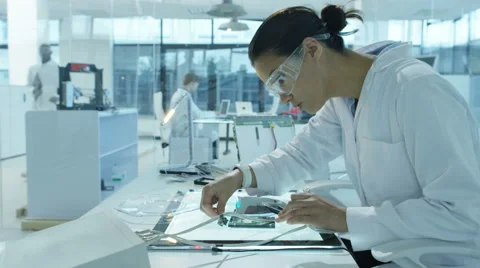 4K Electronics engineers working in lab building &amp; testing circuitry &amp; robotics Stock Footage 67707062