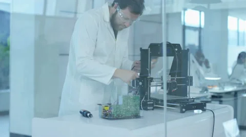 4K Electronics engineers working in lab, building components with 3D printer Video stock 67721314