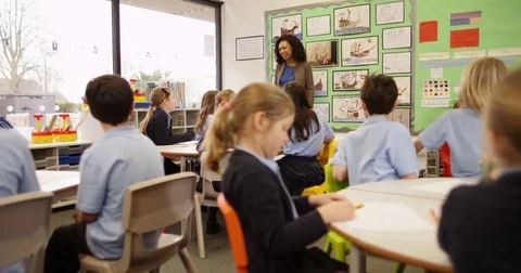 4K Elementary school children listening attentively to the teacher in classroom Stock Footage