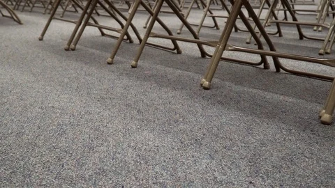 4k. Empty meeting room with rows of foldable chairs. Small girl comes in. 스톡 동영상 91338473