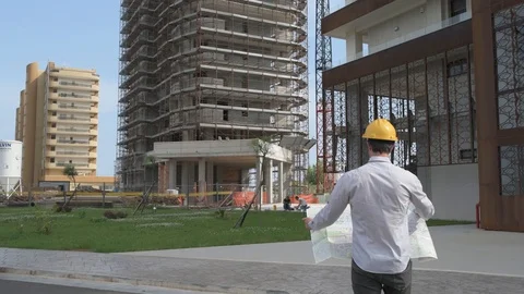 4K engineer and worker walking towards building Video stock 92296645