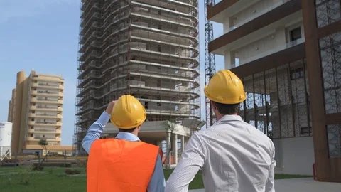 4K engineer confronting worker on building site and shaking hands Stock Footage 92296923