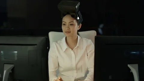 4K Engineer wearing VR viewer at desk with animated graphic in background Video stock 75966355