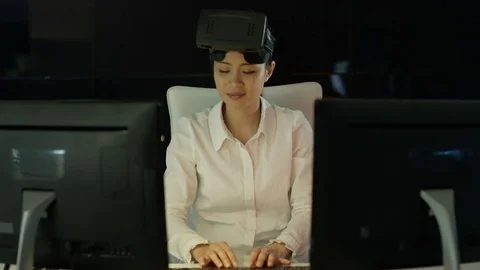 4K Engineer wearing VR viewer at desk with animated graphic in background Video stock 75967452