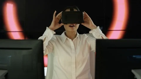 4K Engineer wearing VR viewer at desk with animated graphic in background Video stock 75967759