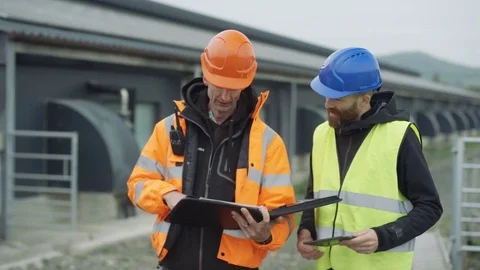 4K Engineers discussing operations at solar energy plant Stock Footage 70013379