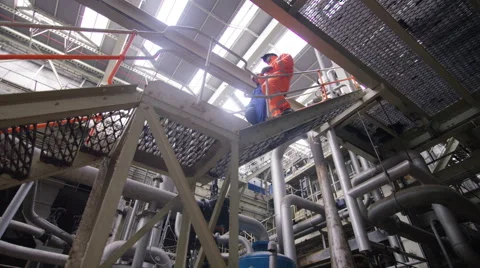 4K Engineers in the power industry shake hands at the end of a tour of the plant Stock Footage