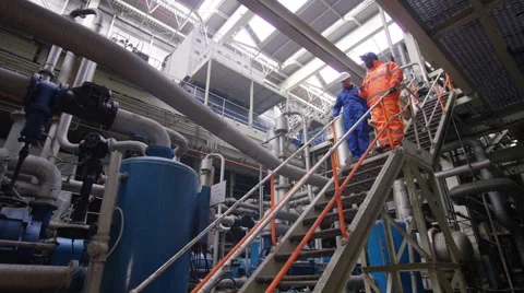 4K Engineers in the power industry walking through plant & discussing operations Stock Footage