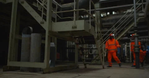 4K Engineers in the power industry walking through plant & discussing operations Stock Footage