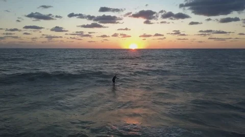 4K epic Aerial fly over ocean Paddle Boarder at sunset pan Stock Footage 75659049