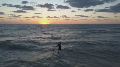 4K Epic Aerial view of Paddle Boarder at sunset zoom move Stock Footage 75659077
