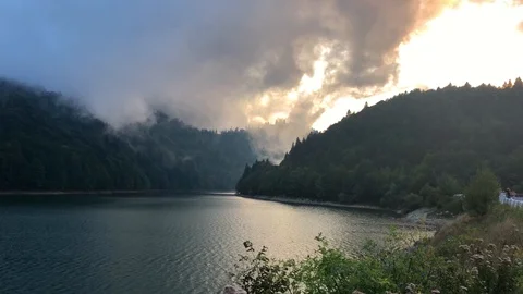 4K Epic Clouds Over Lake and Mountains At Sunset Stock Footage 94592475