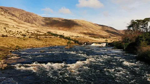 4k epic low aerial over river with waterfall and mountain Ireland Video stock 89232300