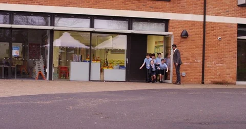 4k, Excited group of school children running out of a school building Stock Footage