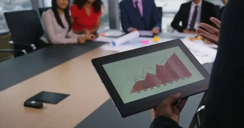 4k, An executive leading a digital presentation to colleagues in a boardroom Stock Footage 69152515