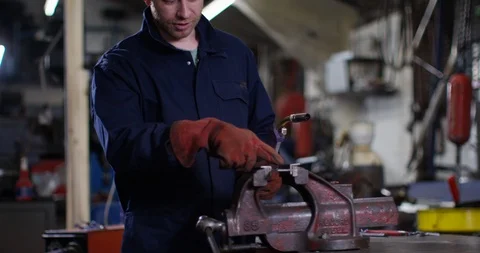 4K Experienced mechanic teaching young apprentice how to weld metal in workshop Video stock 113099205