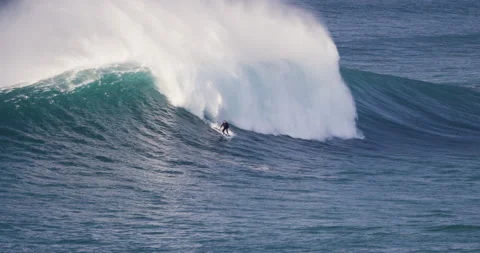 4K of experienced surfer being washed away by giant rolling wave in Portugal Stock Footage 163078029