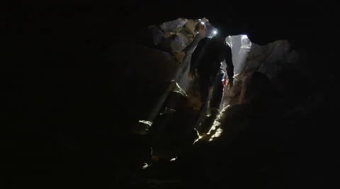 4K Explorers Entering a Mysterious Cave Stock Footage