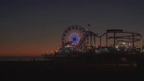4K EXT NIGHT static shot Venice beach while sunset with lit carousel Stock Footage 73110347