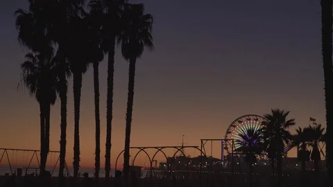 4K EXT NIGHT static Venice beach while sunset with a lit carousel and palm trees Stock Footage 73110160