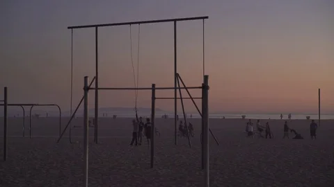 4K EXT NIGHT static Venice beach while sunset with swings and childern Stock Footage 73110174