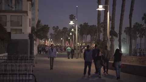 4K EXT NIGHT static Venice beach promenade while sunset with walking people Stock Footage 73110237