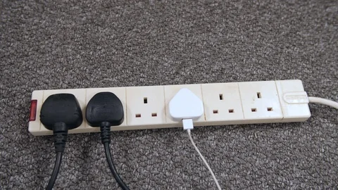 4k Extension cord lead in school home office with British plugs in sockets,   Stock Footage 88270907