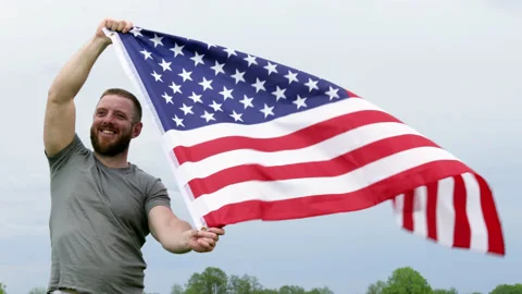 4k. Extremely happy satisfied man holding in hands big American flag Stock Footage 154575534
